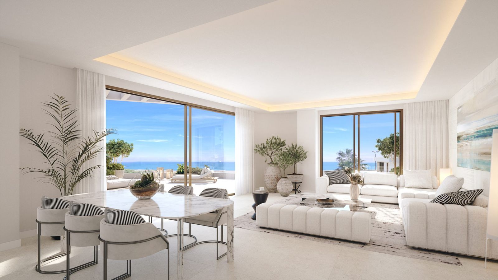 Sala de estar moderna con vista al mar, ventanas grandes, muebles blancos y plantas de interior.